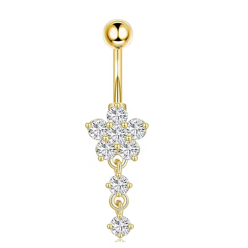 A gold-plated belly button ring featuring a floral cluster of clear cubic zirconia stones and three dangling round-cut stones, shown on a plain white background.