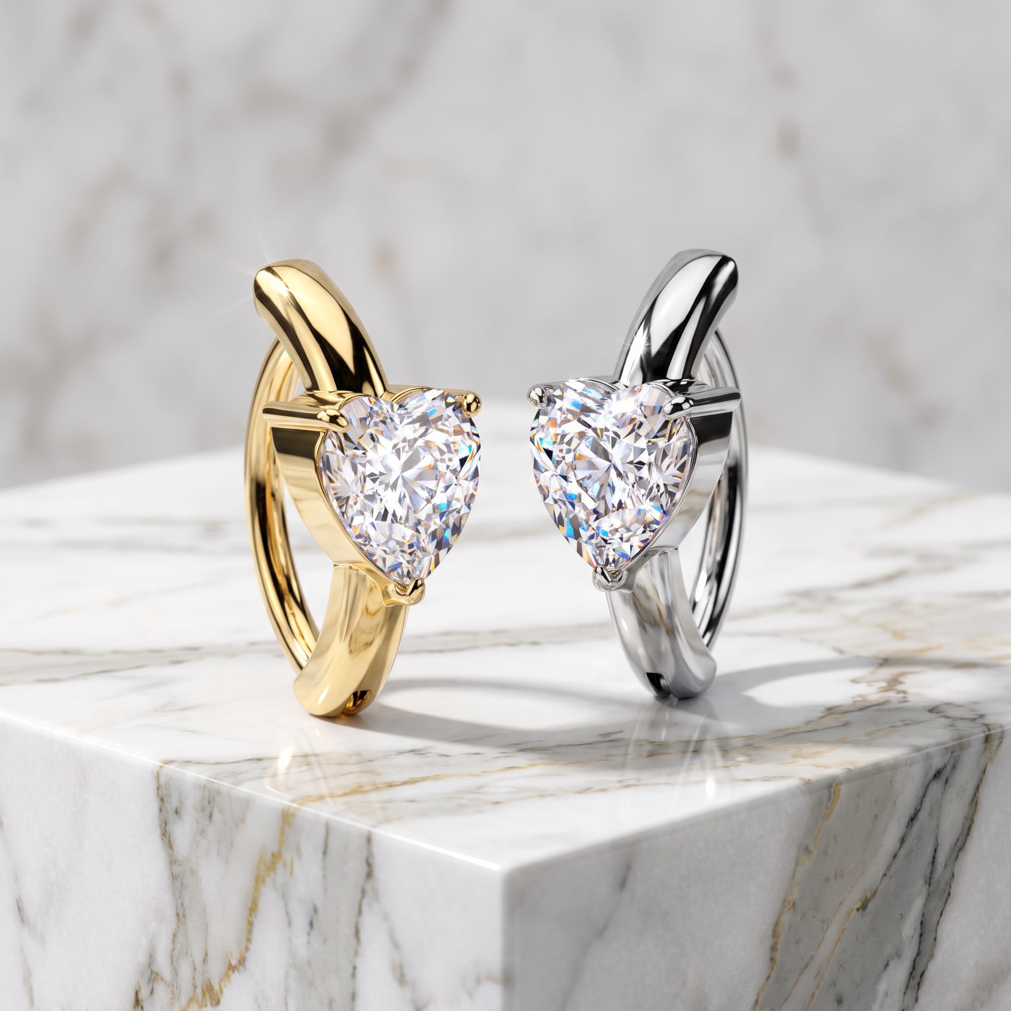 Two heart-shaped diamond rings, one in yellow gold and one in silver, displayed on a white marble pedestal against a marble background.