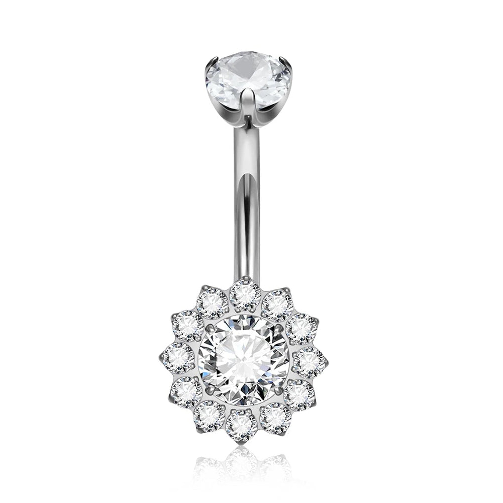 A silver-toned navel piercing ring with a single clear gemstone at the top and a flower-shaped cluster of small clear gemstones at the bottom. An inset circle in the upper right shows the threaded end of the barbell.