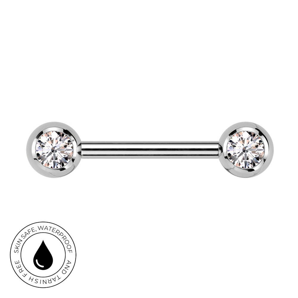 A silver-toned labret piercing barbell with two round bezel-set clear gemstones, shown on a plain white background with a circular 'Skin Safe Waterproof' badge in the lower-left corner.