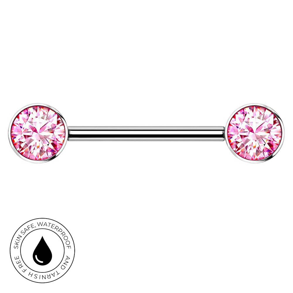 A silver-toned barbell piercing jewelry piece with two round pink gemstones, shown on a plain white background with a small circular 'skin-safe waterproof' badge in the lower left corner.