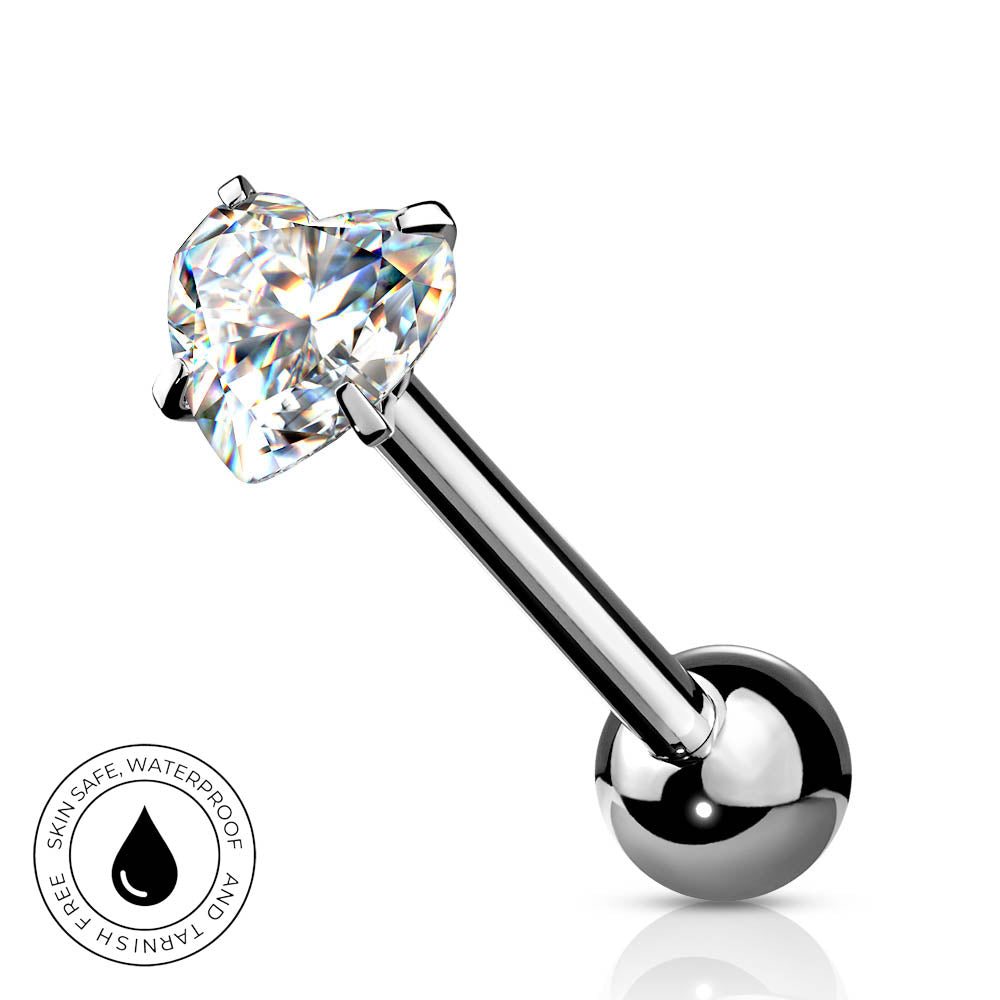 A silver-toned labret piercing barbell with a heart-shaped clear gemstone and a polished ball end, shown on a white background with a small circular 'skin-safe waterproof' badge in the lower left.