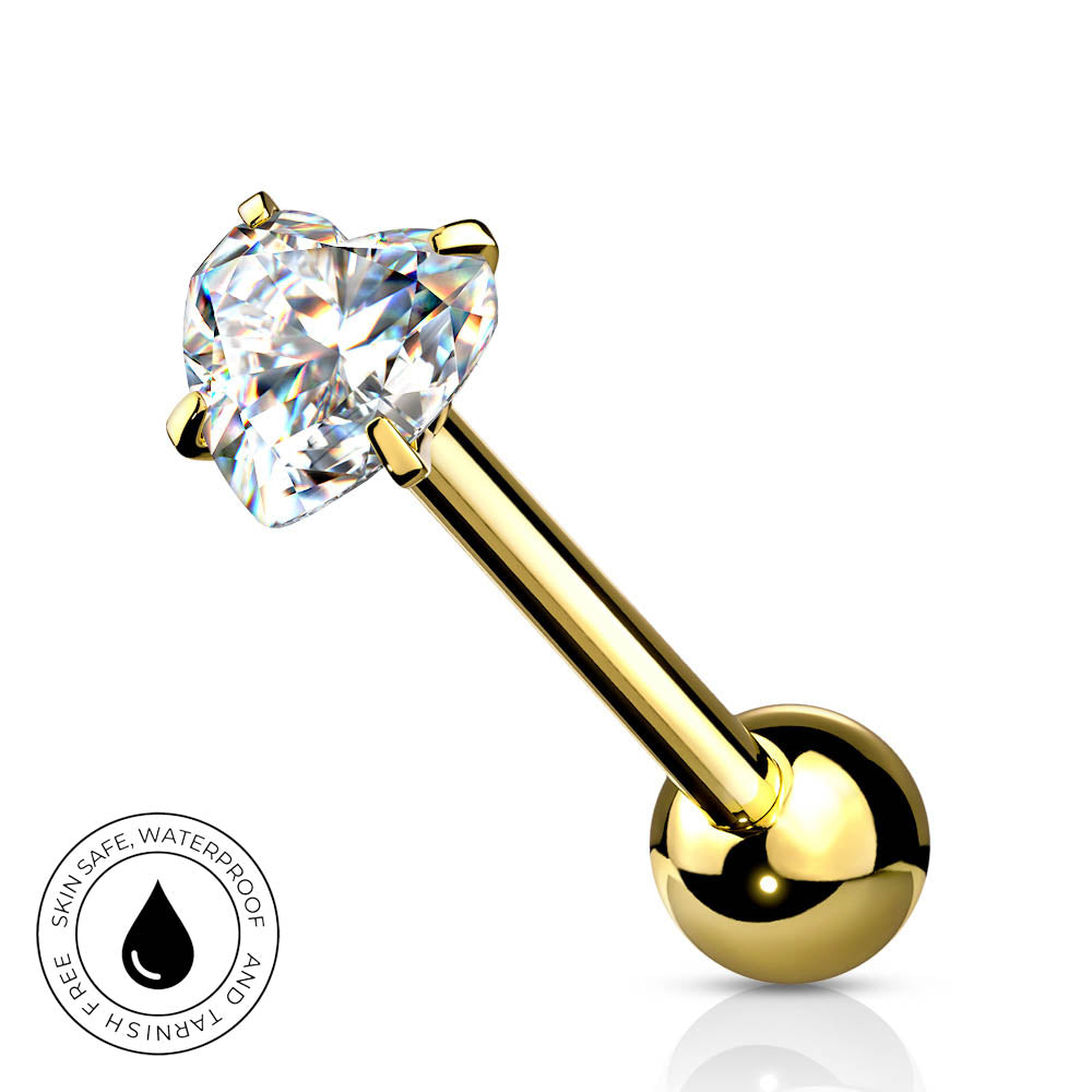 A gold-plated labret piercing barbell with a heart-shaped clear gemstone, shown on a white background with a circular 'SkinSafe Waterproof' badge in the bottom-left corner.