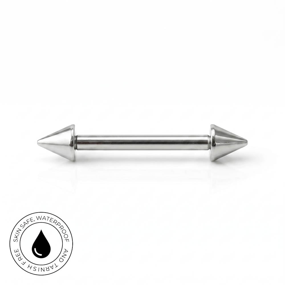 A stainless steel barbell piercing with conical spike ends, shown horizontally on a clean white background with a circular 'Skin Safe, Waterproof' badge in the bottom-left corner.