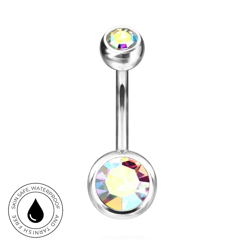 A silver-toned curved barbell belly button ring with a large faceted iridescent crystal on the bottom and a smaller multicolor crystal on the top. A circular badge on the bottom left reads 'SKINSAFE WATERPROOF AND TARNISH FREE'.