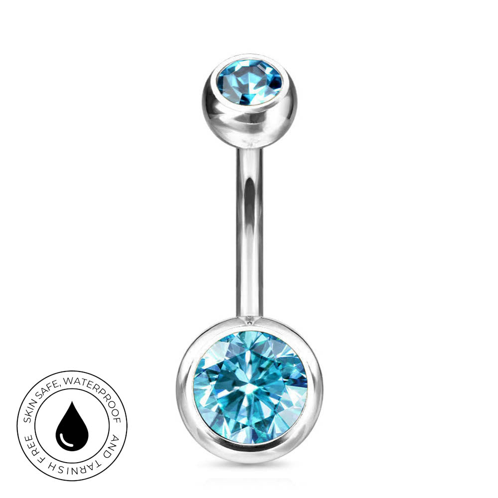 A silver-toned barbell navel piercing jewelry piece featuring a large faceted light blue gemstone on the bottom ball and a smaller matching blue gemstone on the top ball, shown on a white background with a circular 'Skin Safe Waterproof' badge in the lower left.