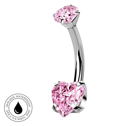 A curved barbell belly button piercing with a polished silver-tone metal band and two pink heart-shaped gemstones, shown on a white background with a circular skin-safe waterproof badge in the lower left.