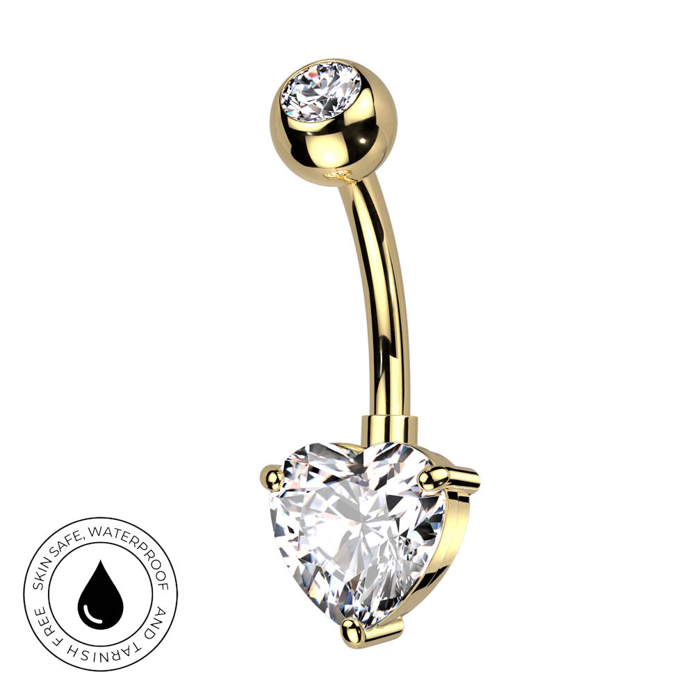 Gold-plated curved barbell belly button ring with a large heart-shaped clear gemstone and a smaller round clear gemstone at the top, shown on a white background with a skin-safe waterproof badge.