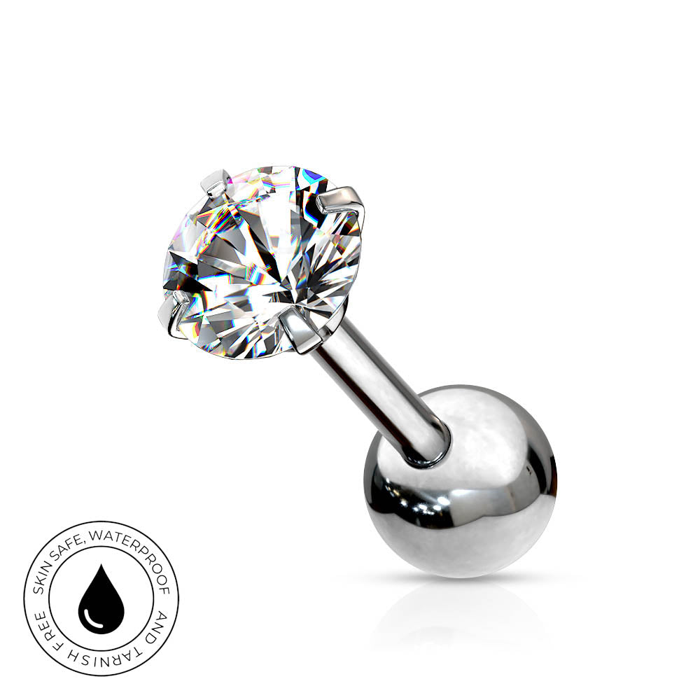 A silver-toned labret piercing barbell with a large, clear, faceted round gemstone on the top and a polished ball end on the bottom. A circular badge in the bottom-left corner highlights the product's skin-safe, waterproof, and tarnish-free qualities.