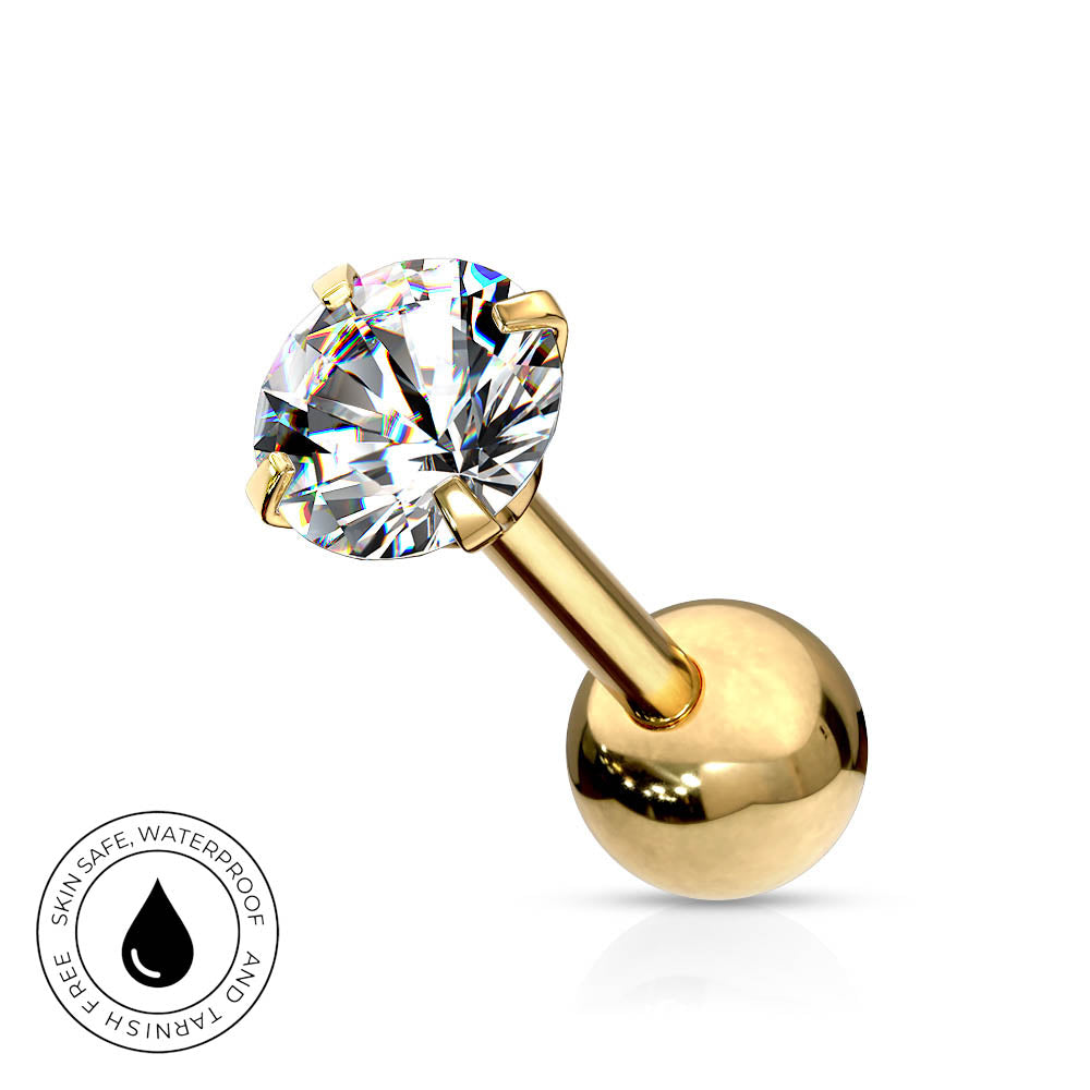 A gold-plated labret piercing stud with a large, round-cut clear gemstone in a four-prong setting and a smooth, polished ball back. A circular graphic badge in the bottom-left corner highlights the product's skin-safe, waterproof, and tarnish-free qualities.