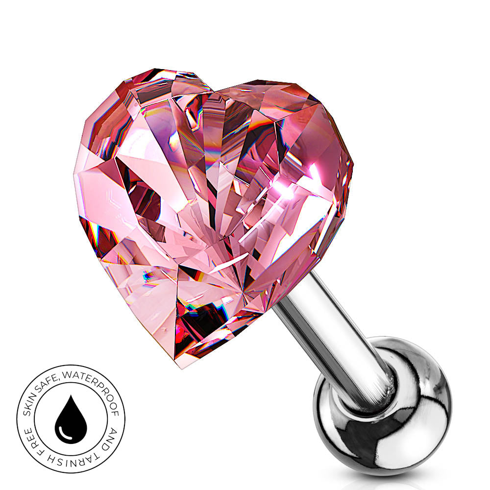 A pink faceted heart-shaped labret piercing stud with a polished silver-tone metal post and ball, shown on a white background with a circular 'Skin Safe Waterproof' badge in the lower left corner.