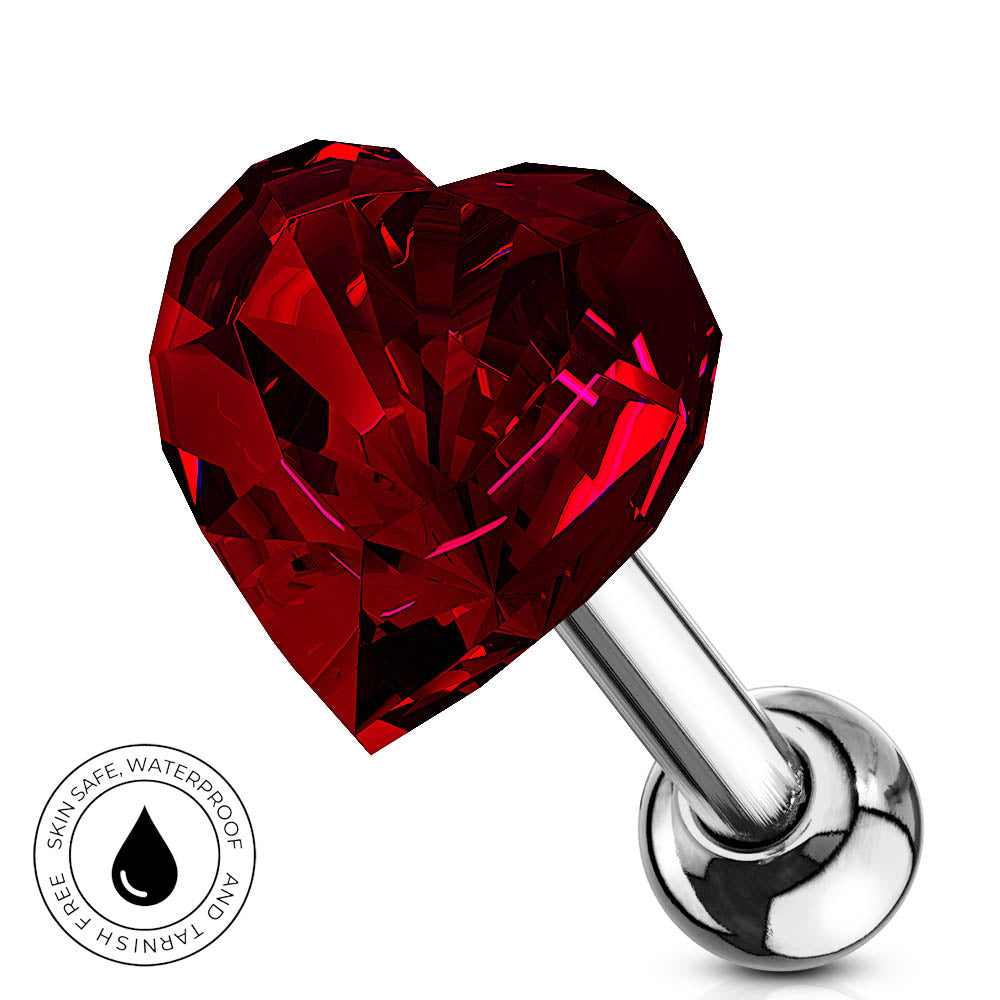 A heart-shaped red faceted gemstone labret piercing barbell on a white background, featuring a silver-colored metal post and ball end. A circular badge in the bottom-left corner reads 'SKIN SAFE WATERPROOF AND TARNISH FREE' with a water droplet icon.