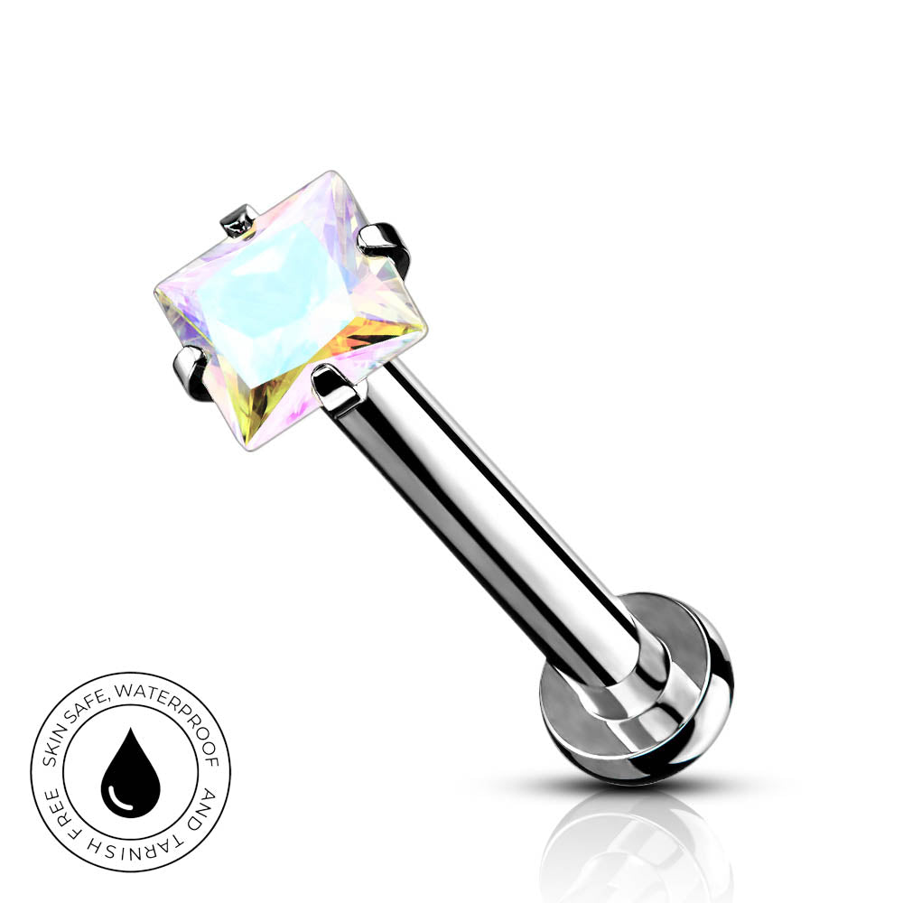 A silver-toned labret piercing barbell with a square iridescent clear gemstone, shown on a white background with a small circular 'Skin Safe Waterproof' badge in the lower left.