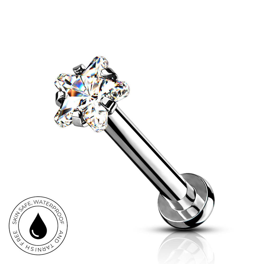 A silver-toned labret piercing barbell with a clear, multi-prong gemstone setting on a white background, featuring a circular 'SkinSafe Waterproof' badge in the lower-left corner.