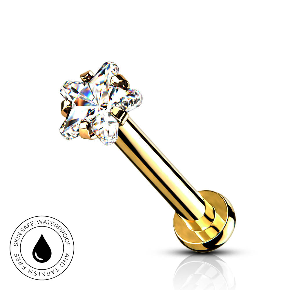 A gold-plated labret piercing barbell with a clear, multi-prong gemstone setting, shown on a white background with a small circular 'SkinSafe Waterproof' badge in the bottom-left corner.