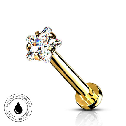 A gold-plated labret piercing barbell with a clear, multi-prong gemstone setting, shown on a white background with a small circular 'SkinSafe Waterproof' badge in the bottom-left corner.