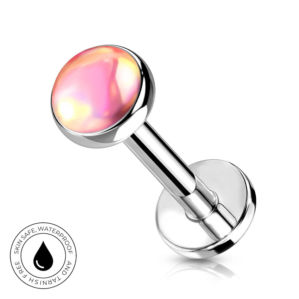 A silver-toned labret piercing barbell with a round, iridescent pink and yellow top, shown on a white background with a small circular 'skin-safe waterproof' badge in the lower-left corner.