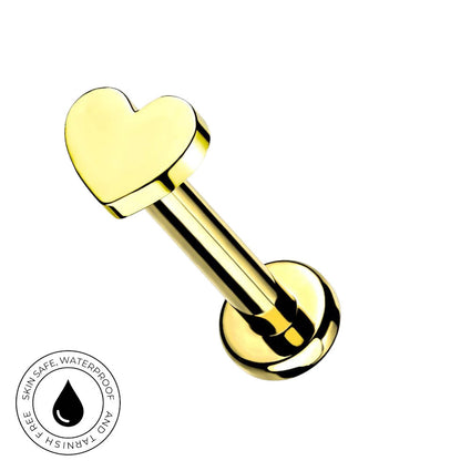 A gold-plated heart-shaped labret piercing stud with a polished finish, shown on a plain white background with a circular 'Skin Safe Waterproof' certification badge in the bottom-left corner.