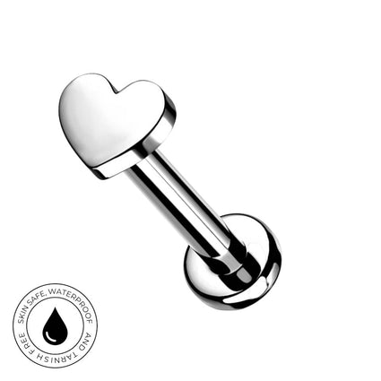 A silver stainless steel labret piercing barbell with a polished heart-shaped end, shown on a plain white background with a circular 'Skin Safe Waterproof' badge in the bottom-left corner.