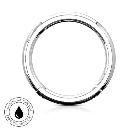 A polished silver-tone circular ring with a small clip or connector at the bottom, shown on a white background with a small circular 'skin-safe waterproof' badge in the lower left.