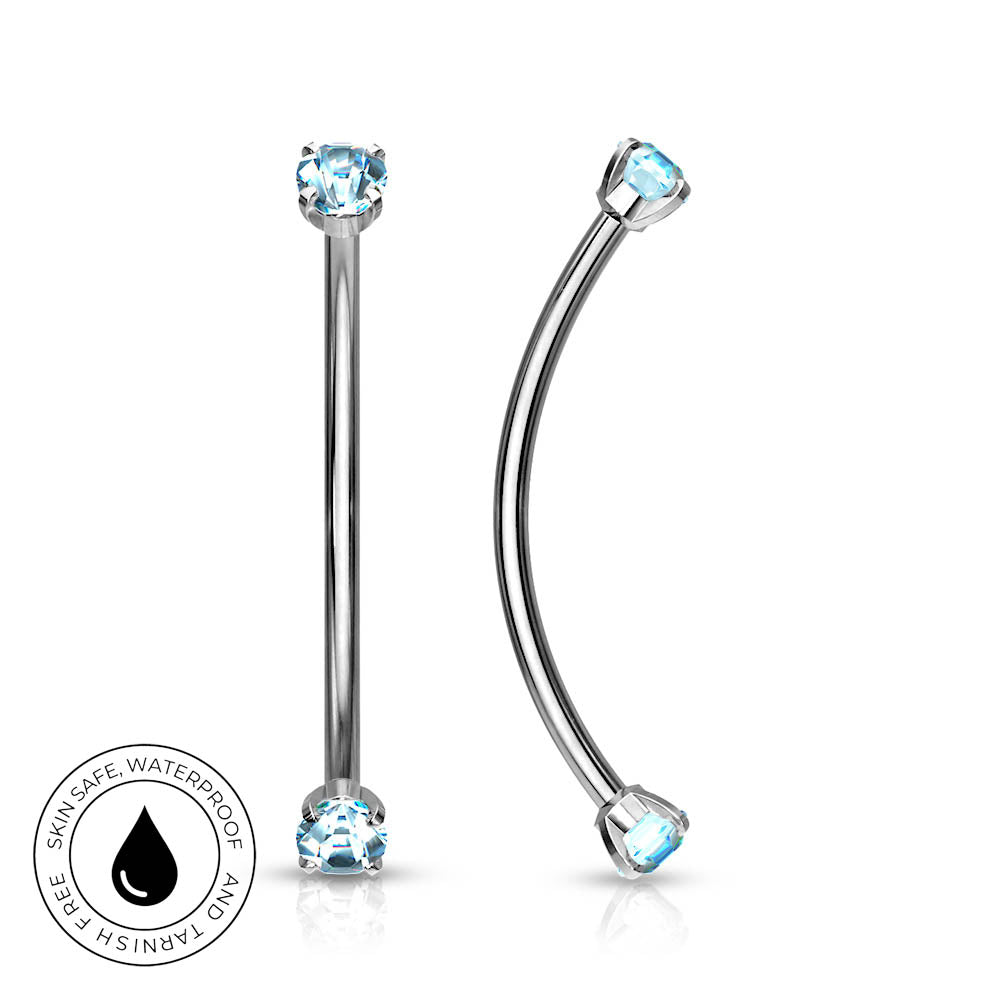 Two silver-toned labret and curved barbell piercings with light blue gemstones, shown on a white background with a circular 'Skin Safe Waterproof' badge in the lower left.
