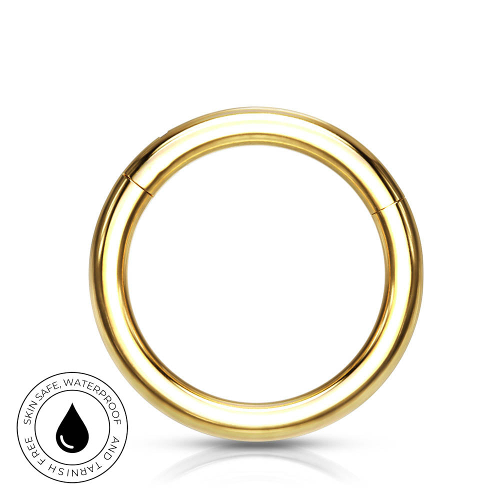 A polished gold-tone circular ring with a small seam line, shown on a white background with a small circular 'Skin Safe Waterproof' badge in the lower-left corner.
