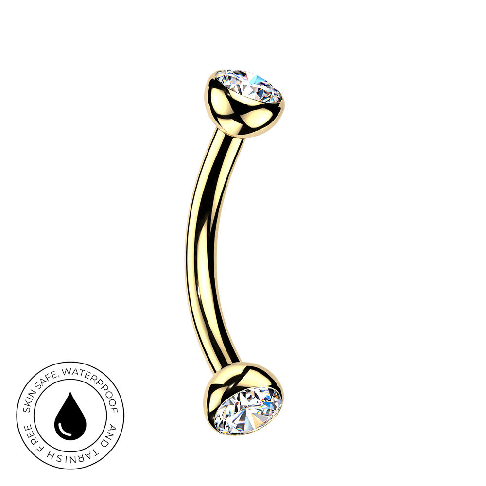 Gold curved barbell piercing jewelry with clear rhinestone ends, shown on a white background with a circular skin-safe waterproof badge in the lower left corner.
