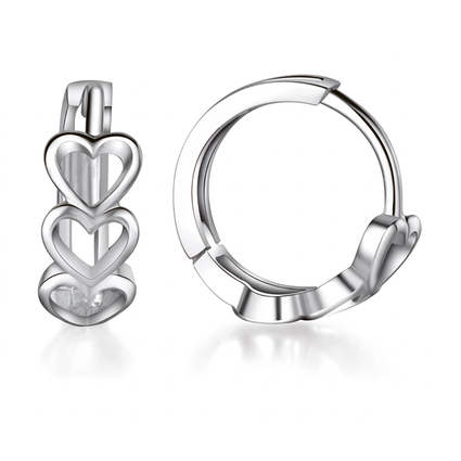A pair of polished silver huggie hoop earrings with stacked heart charms, shown on a clean white background with soft reflections.
