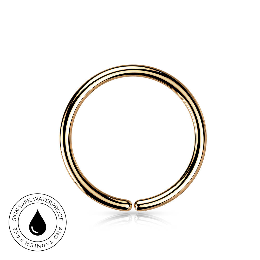A polished gold-plated curved ring nose stud with a triple-band design, shown on a white background with a small circular skin-safe waterproof badge in the bottom-left corner.