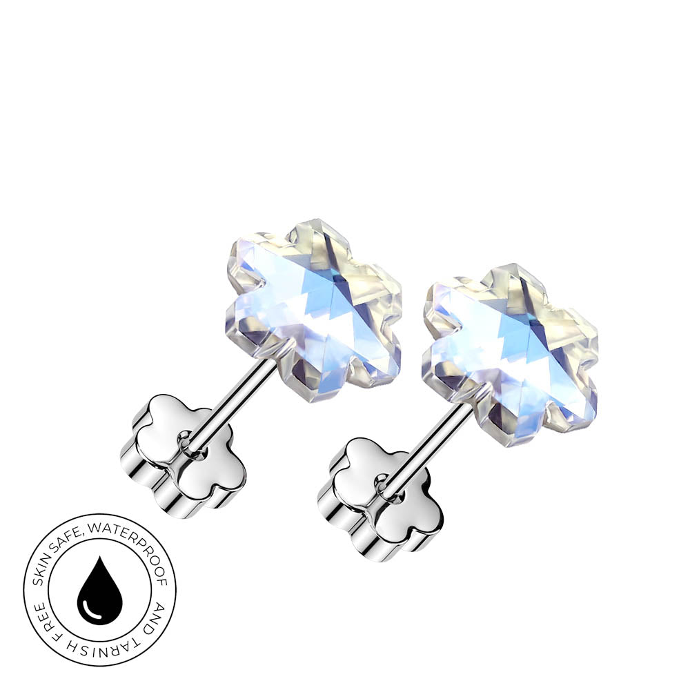 A pair of silver-toned flower-shaped stud earrings with faceted clear gemstones, shown on a white background with a circular 'skin-safe waterproof' badge in the lower left.
