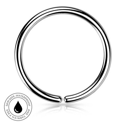A polished silver-tone metal ring piercing band shown on a clean white background, with a small circular badge in the lower left that reads 'SkinSafe Waterproof' and 'Tarnish Free'.