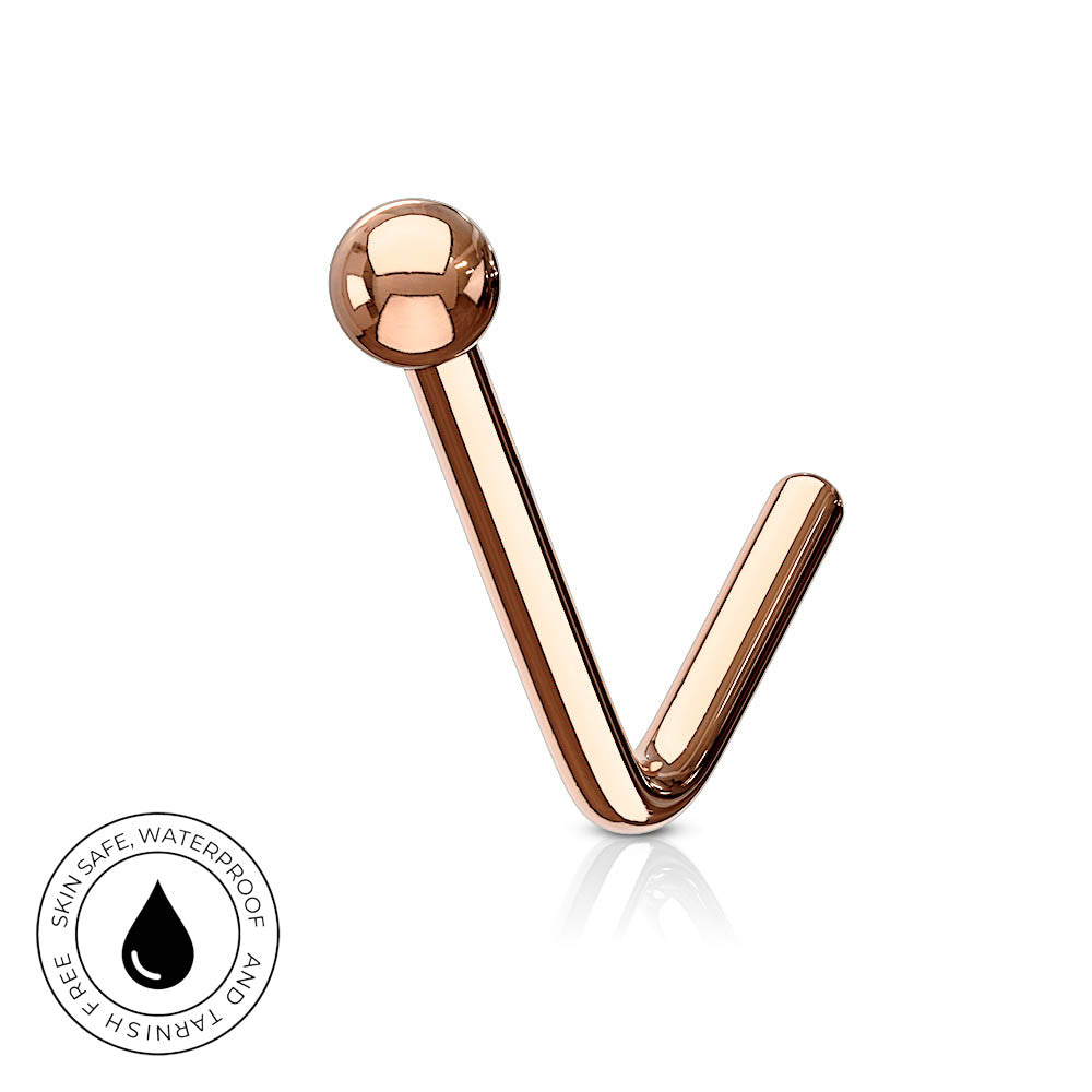 A rose gold curved barbell piercing stud with a spherical ball end, shown on a clean white background with a subtle reflection. A circular badge in the bottom-left corner highlights its skin-safe, waterproof, and tarnish-free qualities.