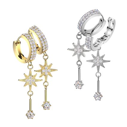 Two pairs of huggie hoop earrings with dangling star and key motifs, shown in yellow gold and silver metal finishes. The hoops and stars are set with clear pavé stones, and each dangling piece culminates in a round clear stone.