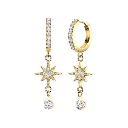 A pair of gold dangle earrings on a plain white background. One earring is a huggie hoop with a vertical bar set with clear stones, and the other is a drop earring with a starburst motif, a small link, and a round clear gemstone.