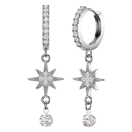 A pair of silver-toned dangle earrings with pavé-set clear stones, featuring a huggie hoop, a vertical bar, an eight-pointed star, and a dangling round crystal charm, shown on a plain white background.