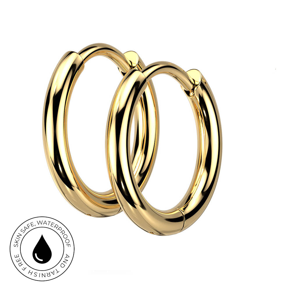 Two polished gold hoop earrings shown on a plain white background, with a circular inset badge at the lower left reading 'Skin Safe, Waterproof, and Tarnish Free' with a droplet icon.