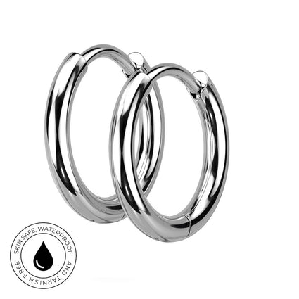 Two polished silver hoop earrings overlapping on a white background, with a circular 'Skin Safe Waterproof' badge in the lower-left corner.
