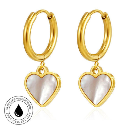A pair of gold hoop earrings with heart-shaped dangles featuring a white mother-of-pearl inlay, shown on a white background with a circular 'Skin Safe Waterproof' badge in the lower-left corner.