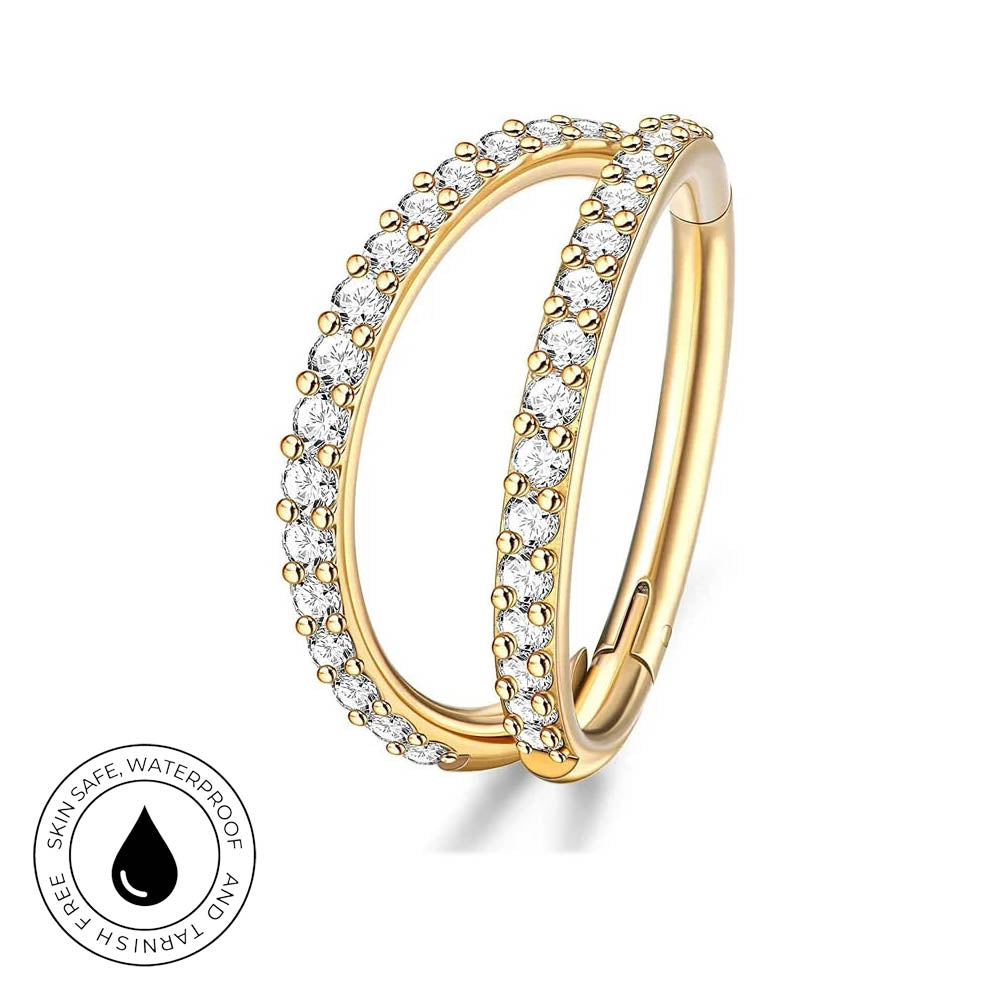 A pair of gold hoop earrings with clear pavé-set round stones, shown on a white background with a circular 'Skin Safe Waterproof' badge in the lower-left corner.