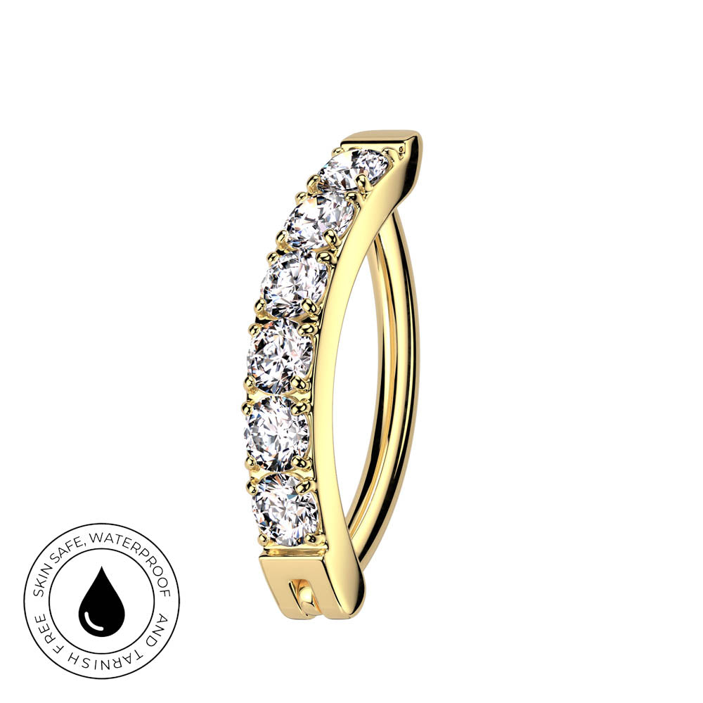A curved gold hoop ring featuring a row of clear cubic zirconia stones on the front, shown against a plain white background with a circular 'Skin Safe Waterproof' badge in the bottom-left corner.