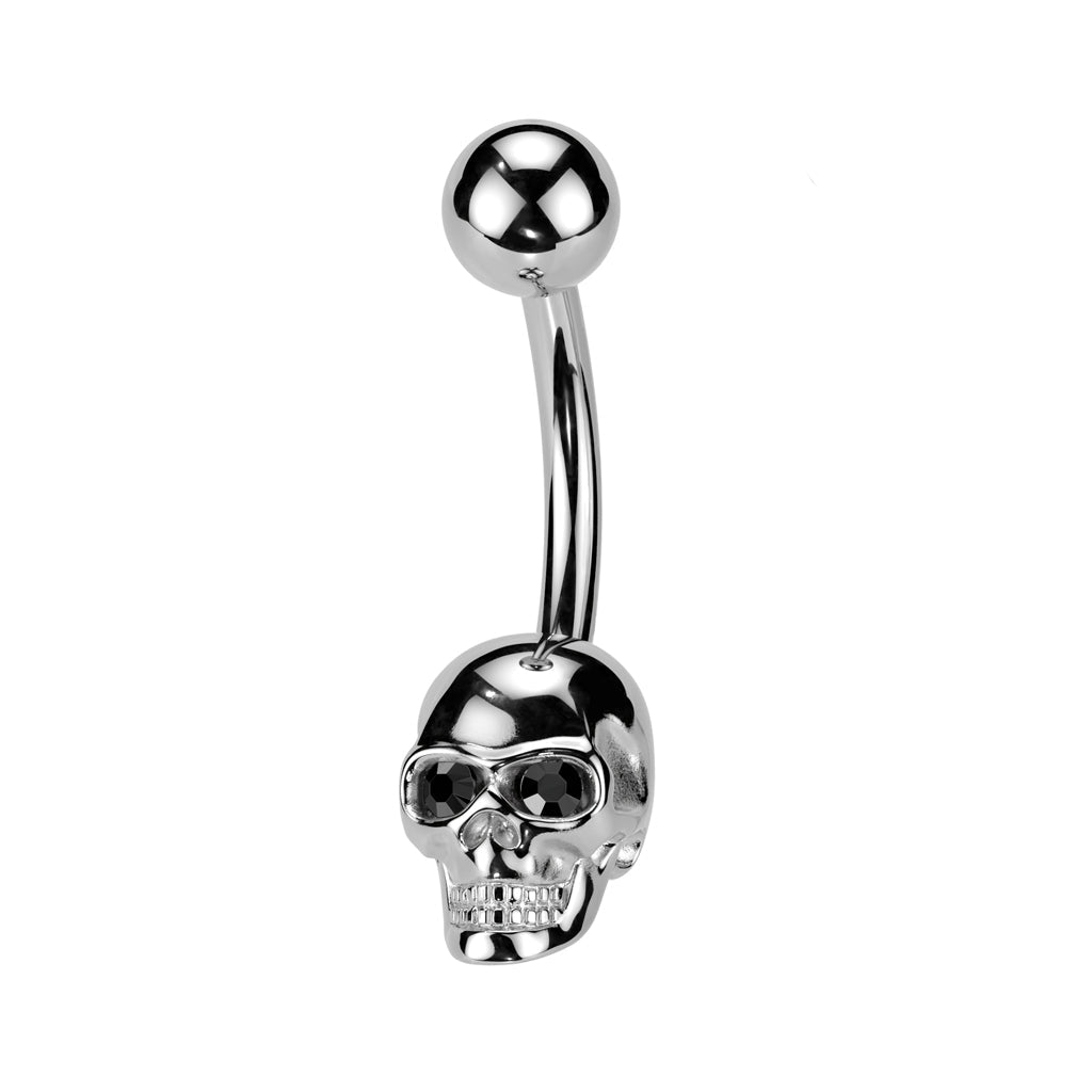 A polished silver-tone curved barbell belly button piercing with a skull-shaped end and a small ball end, shown on a plain white background with a smaller inset view of the skull detail.
