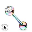 An iridescent rainbow barbell piercing stud with a clear faceted crystal on one end and a metallic ball on the other, shown on a white background with a circular 'Skin Safe Waterproof' badge in the lower-left corner.