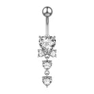 A silver-toned belly button ring featuring a heart-shaped clear gemstone at the top, three dangling heart-shaped clear gemstones below, and a small bow motif in the center, shown on a plain white background.
