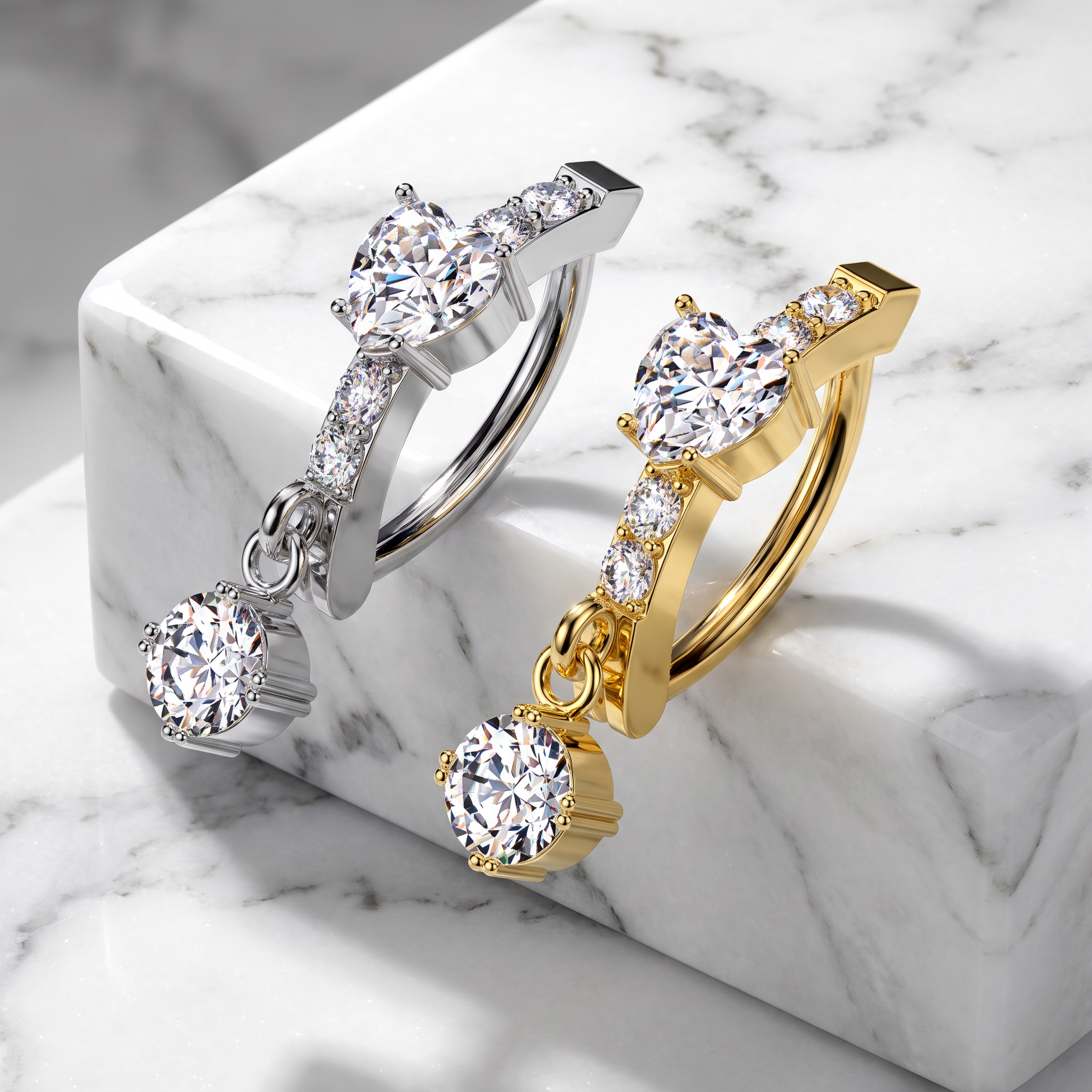 Two huggie hoop earrings with dangling round-cut gemstones, shown on a white marble block. One earring is silver-toned and the other is gold-toned, both accented with small pavé-set stones.