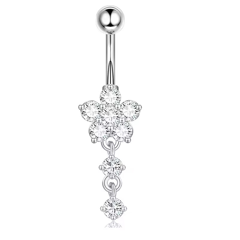 A silver-toned navel piercing barbell featuring a flower-shaped cluster of clear cubic zirconia stones, with three dangling round-cut stones below, set against a plain white background.