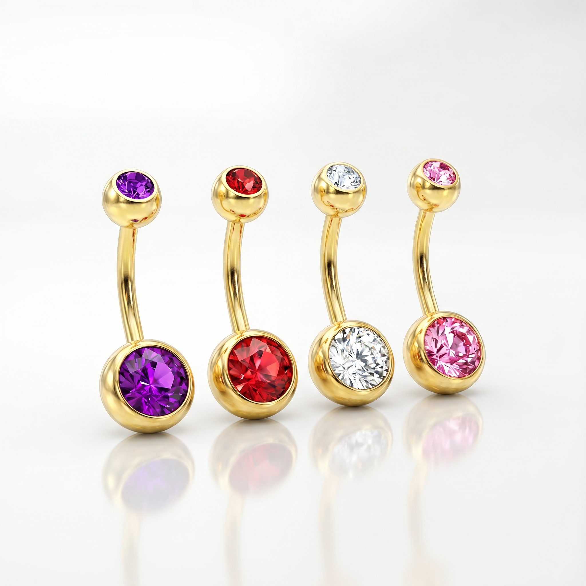 Four gold curved barbell belly button rings with round faceted gemstones in purple, red, clear, and pink, arranged on a reflective white surface.
