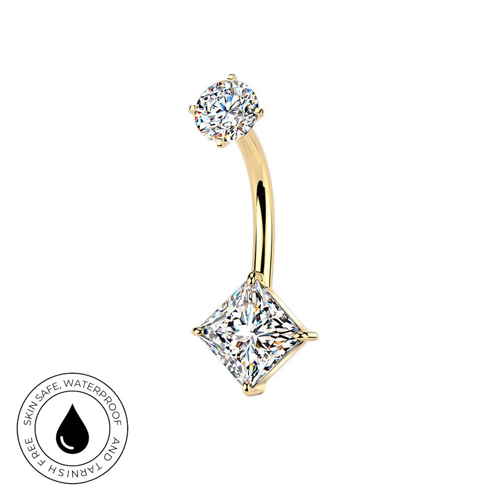 A curved gold navel piercing ring featuring a round clear gemstone at the top and a larger square princess-cut clear gemstone at the bottom, shown on a white background with a circular skin-safe waterproof badge in the lower-left corner.
