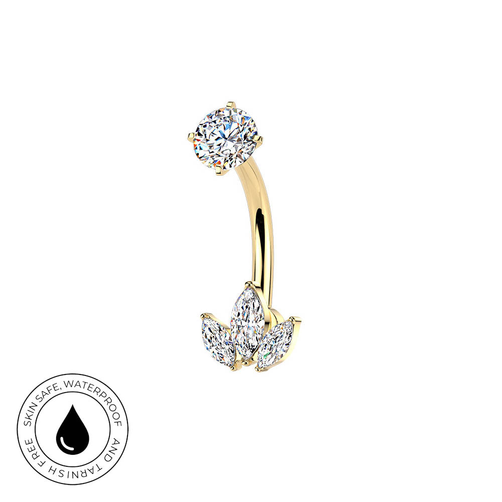 Gold curved barbell piercing stud with a round clear gemstone on one end and a three-stone leaf cluster on the other, shown on a white background with a circular skin-safe waterproof badge in the lower left.