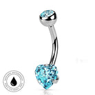 A curved barbell belly button ring with a polished silver-tone metal setting, featuring a large faceted light blue heart-shaped crystal on the lower end and a smaller matching light blue oval crystal on the upper end. A circular 'Skin Safe Waterproof' badge is shown in the bottom-left corner on a plain white background.