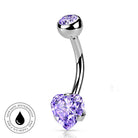 A curved silver-toned barbell belly button ring with a heart-shaped light purple gemstone on one end and a round purple gemstone on the other, shown on a white background with a small circular skin-safe waterproof badge in the lower left.